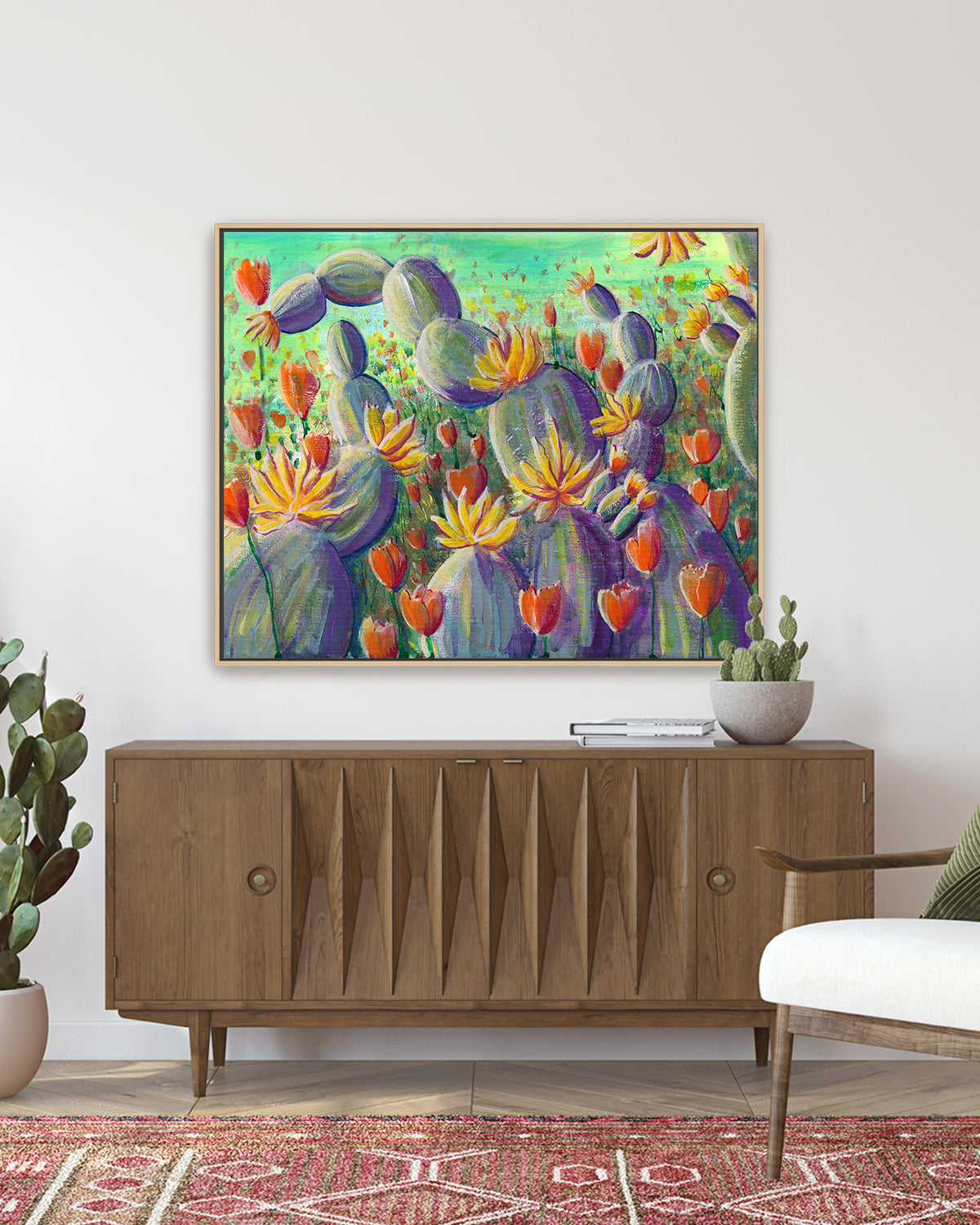 Flowering Cacti No. 002 framed canvas art print featuring flowering cacti and poppies. Mockup above a living room console table.