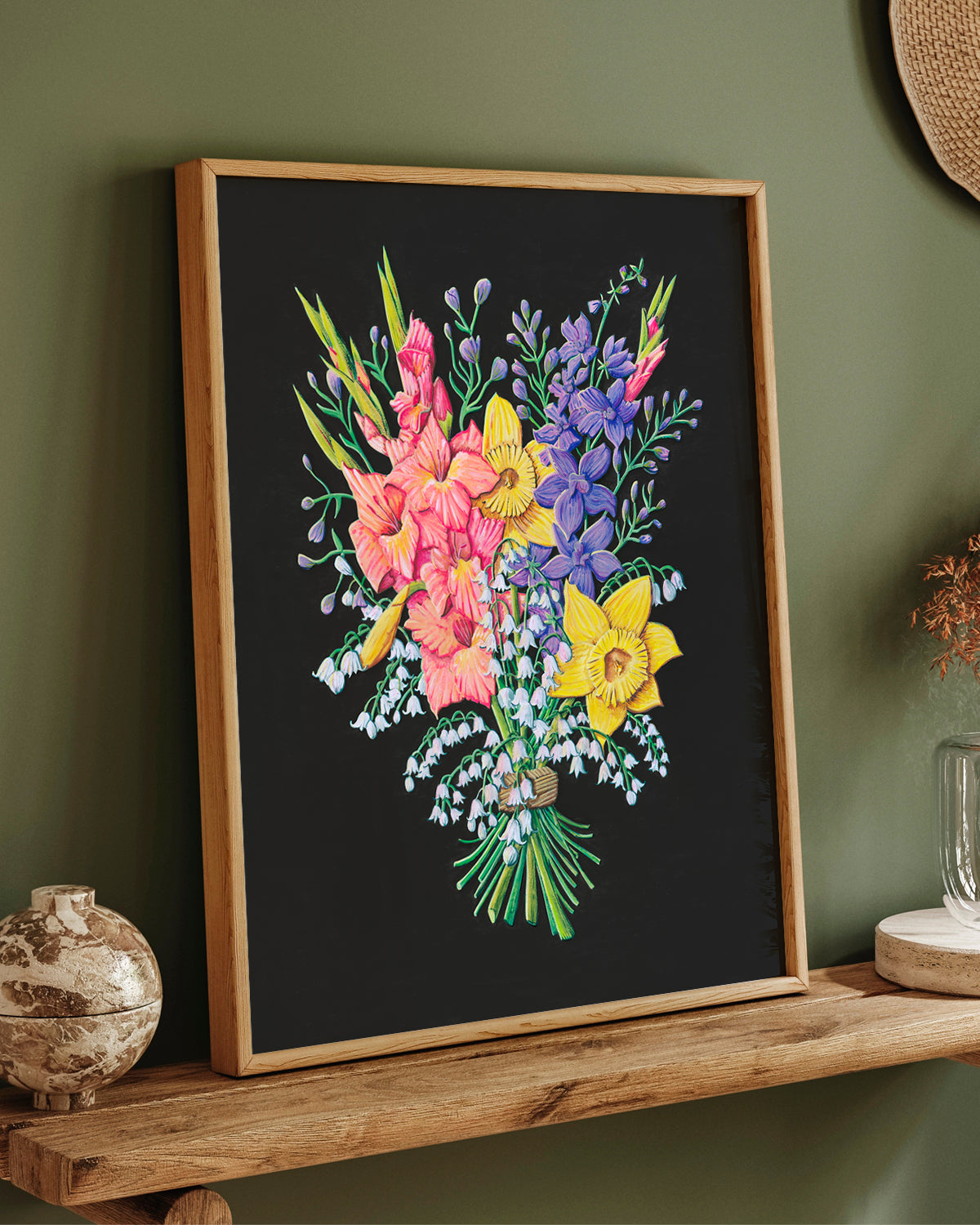 Framed floral artwork by Jen Montgomery on a dark background against a green wall.