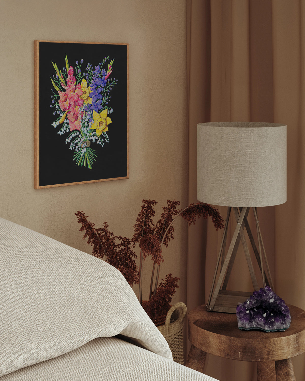 Decorative floral art print by Jen Montgomery on a wall above a bed with a lamp and plant on a side table.