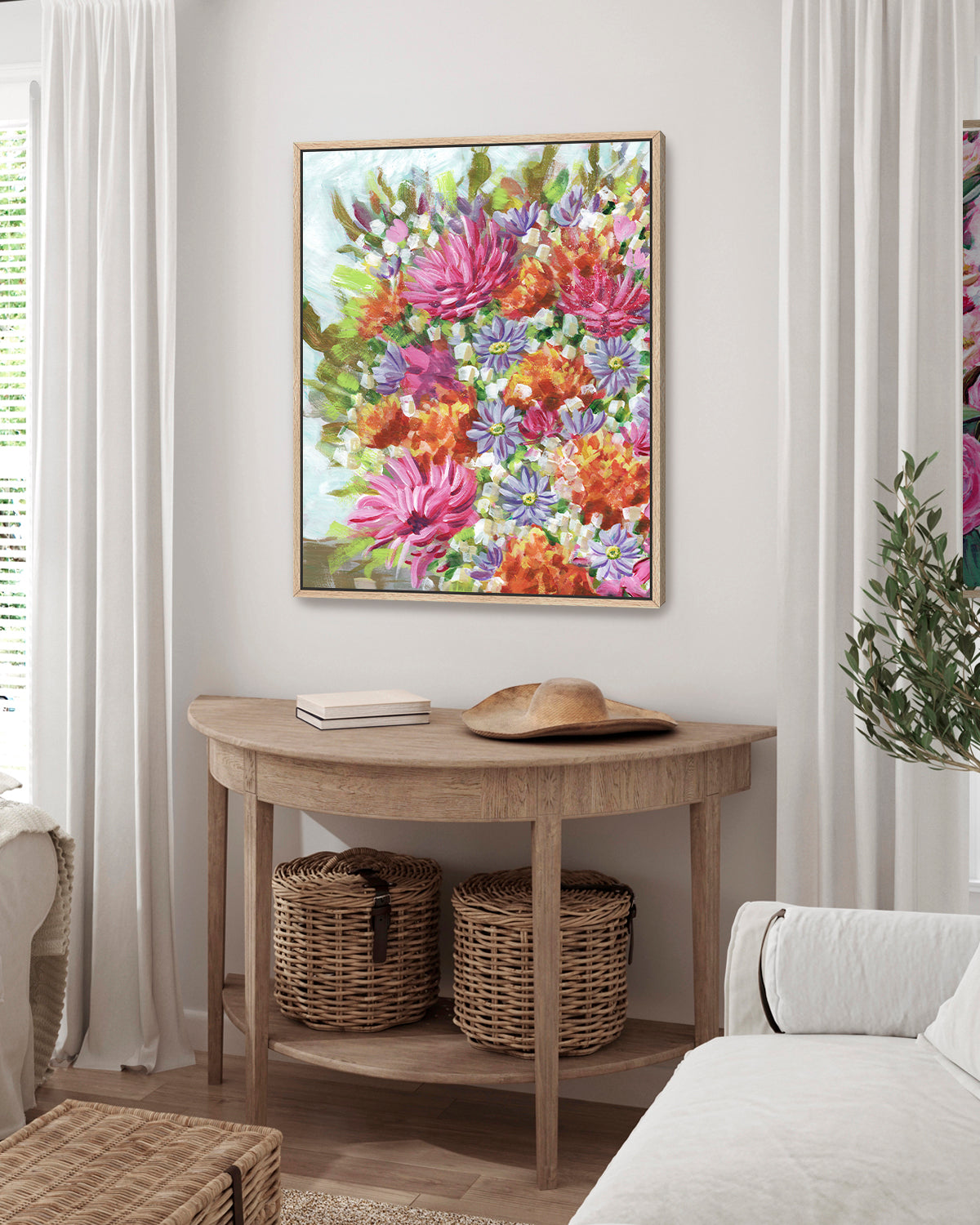 Bouquet No. 005 framed canvas art print featuring vibrant pink, orange, and purple flowers. Mocked up above a wooden console table in a living room.