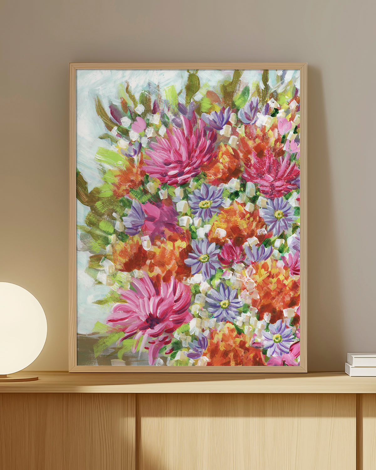 Bouquet No. 005 framed fine art print featuring vibrant pink, orange, and purple flowers. Mocked up on a wooden shelf against a beige wall