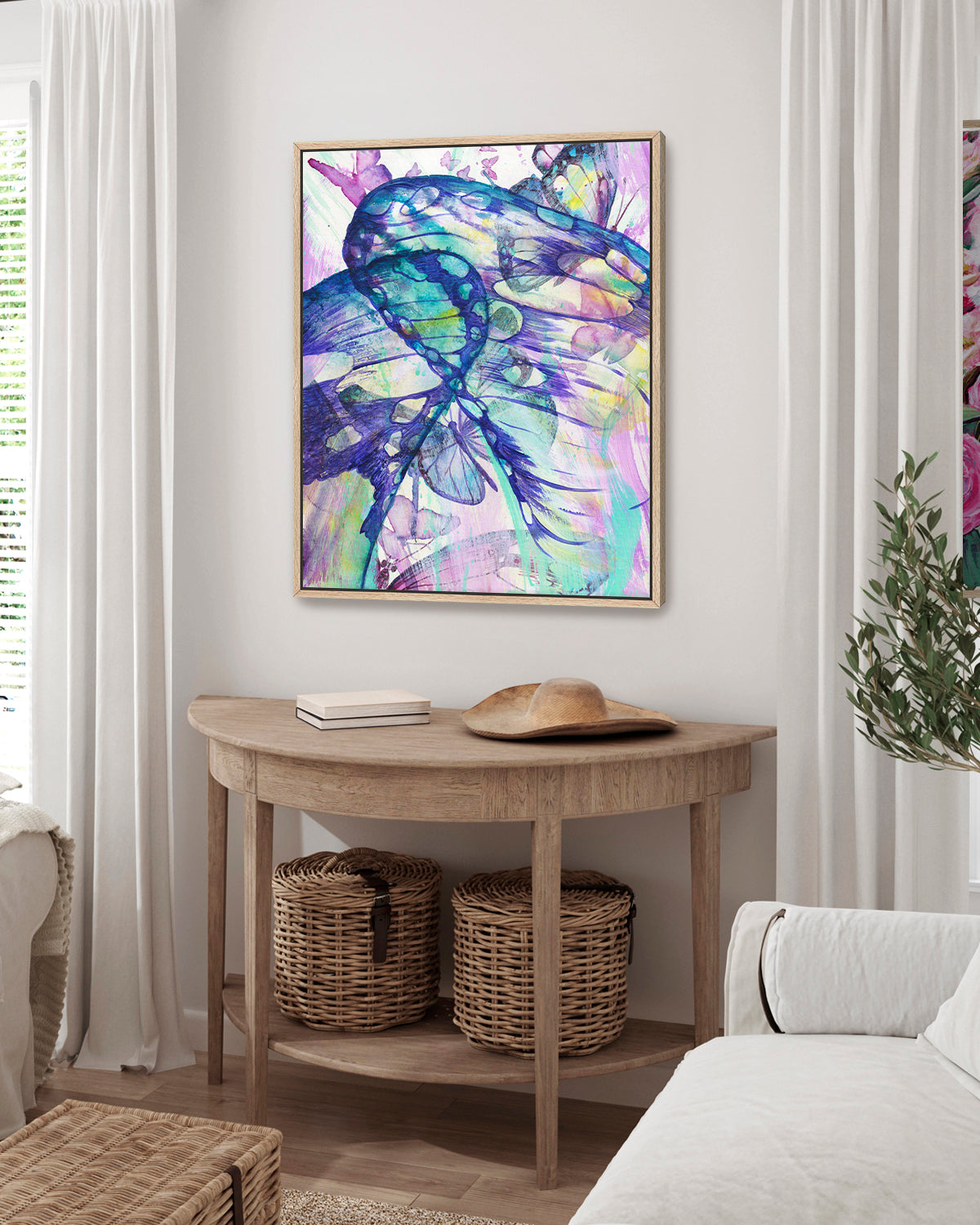 Surged Veil framed canvas art print featuring butterfly wings from the point of view of being inside of a cocoon. Mockup above a console in a living room.
