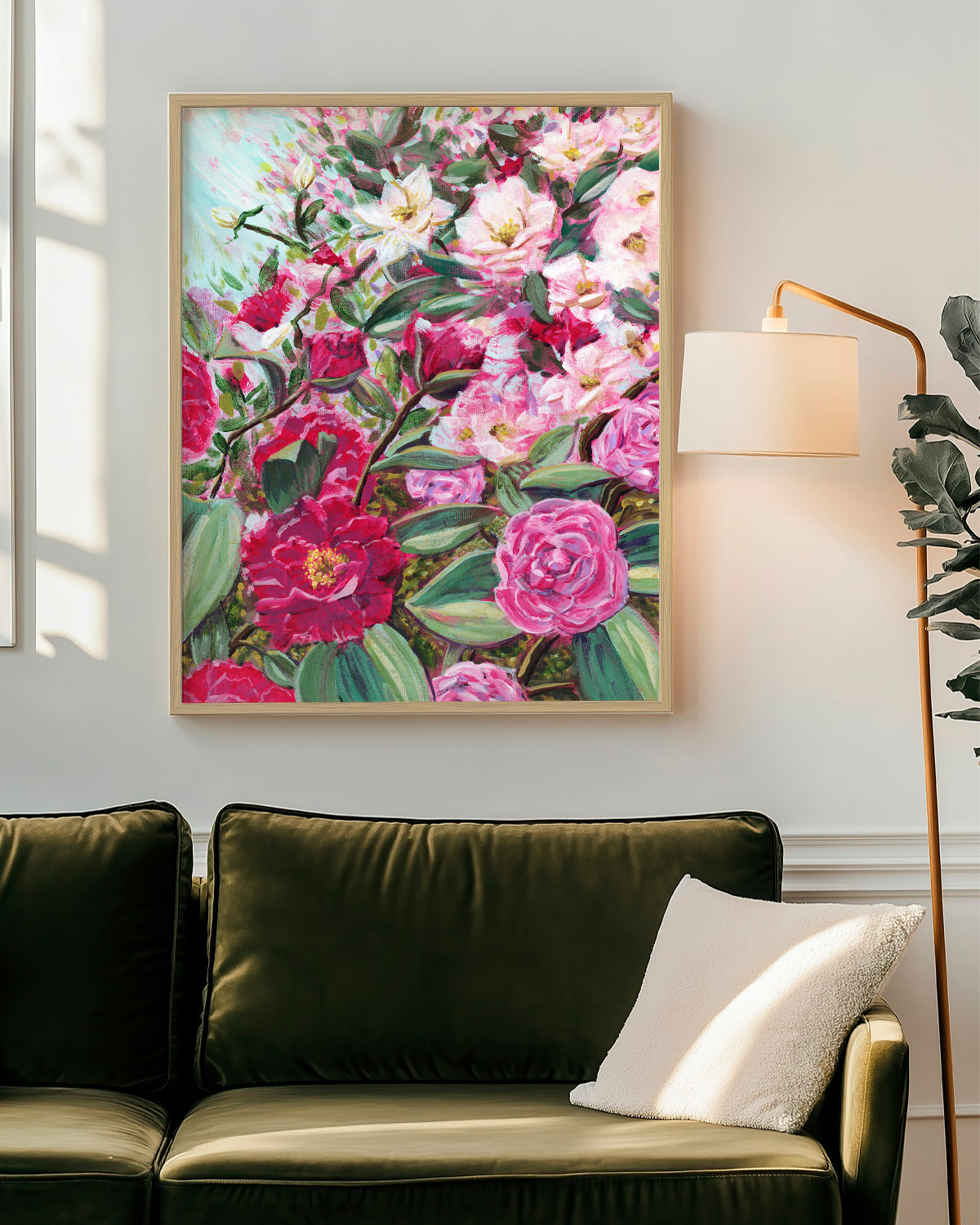 Echoes in Bloom framed art print featuring Camellias and white tea roses. Mockup above a sofa.