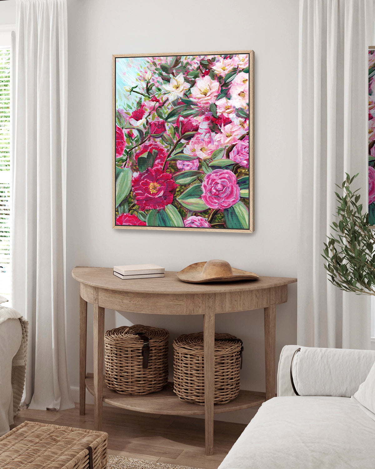 Echoes in Bloom framed canvas art print featuring Camellias and white tea roses. Mockup above a console table in a living room.
