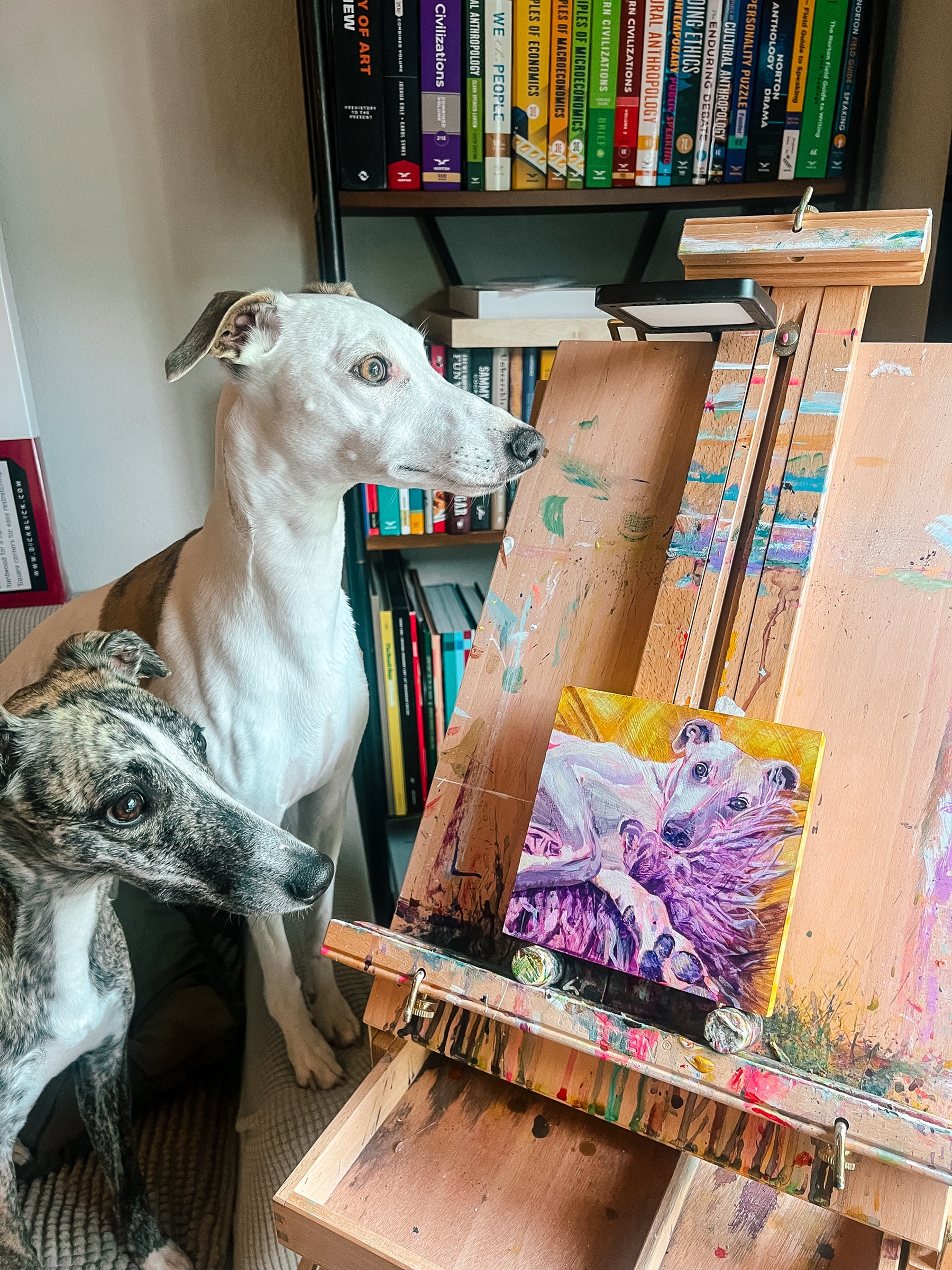 Jen Montgomery's two dogs in a room with art supplies and books