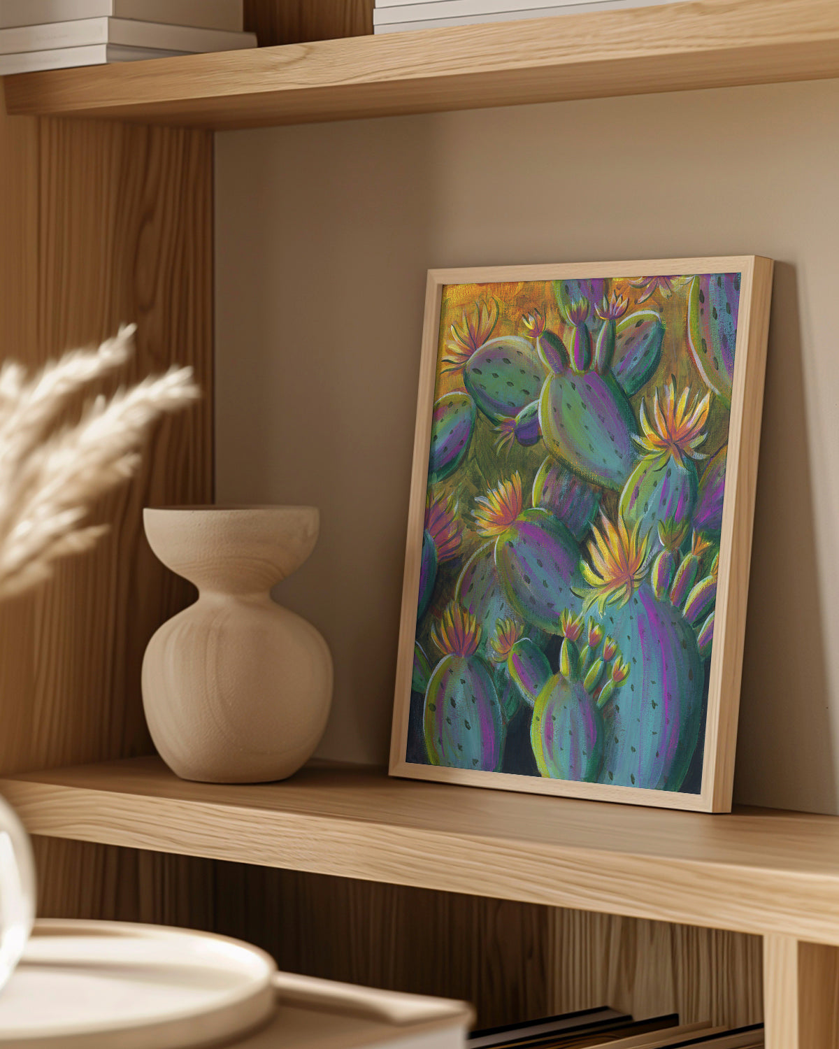 Flowering Cacti No. 001 framed art print featuring flowering cacti. Mockup on a wood shelf.
